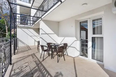 a patio with a table and chairs on a balcony at Apartments Natali in Bar