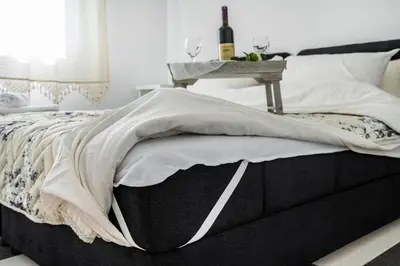 a bed with a table on top of it at Apartments Natali in Bar