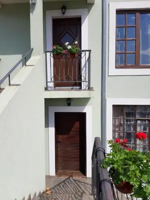 a building with a balcony with flowers on it at Vila Maljevik in Sutomore