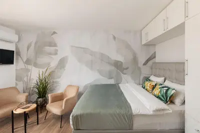 a bedroom with a bed with a mural on the wall at Kotor Sunrise Apartments in Kotor