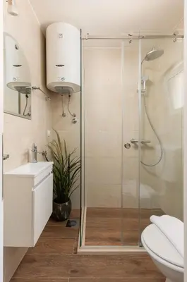 a bathroom with a shower and a toilet and a sink at Kotor Sunrise Apartments in Kotor