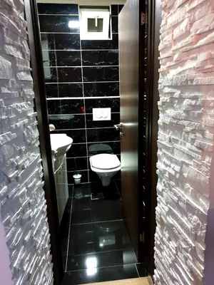 a bathroom with two sinks and a toilet in it at Apartmani vuk in Cetinje