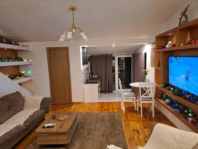 a living room with a couch and a large screen tv at Apartmani vuk in Cetinje