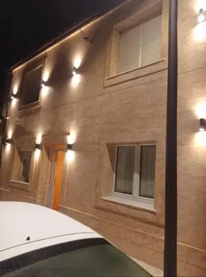 a building with lights on the side of it at Apartmani vuk in Cetinje