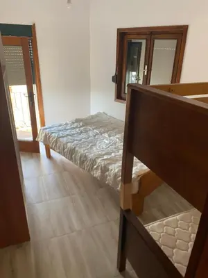 a bedroom with a bed and a staircase with a mirror at Jednosoban stan Lucija in Bar