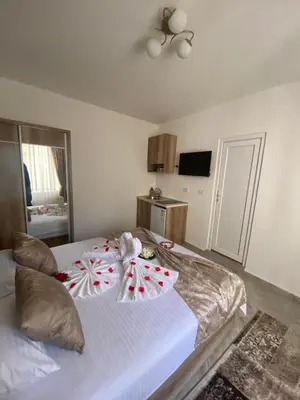 a bedroom with two beds with christmas decorations on them at Apartments Gusar in Ulcinj