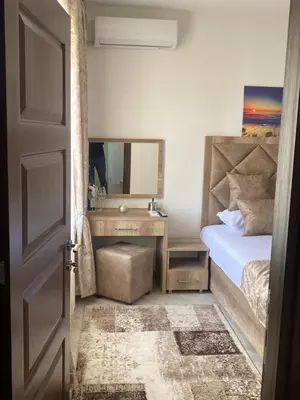 a bedroom with a bed and a desk with a mirror at Apartments Gusar in Ulcinj