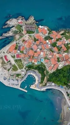 an island in the ocean with red roofs at Apartments Gusar in Ulcinj