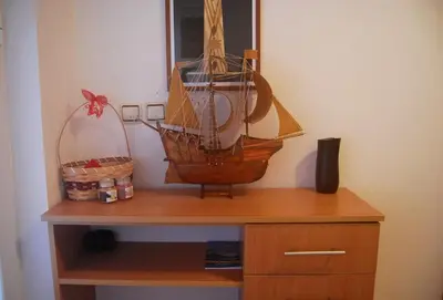 a wooden model of a boat on top of a cabinet at Omega Apartments in Ulcinj
