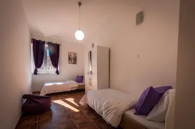 a bedroom with two beds and a window at Old Town Experience Apartment in Kotor