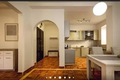 a large kitchen with an archway in the middle at Old Town Experience Apartment in Kotor