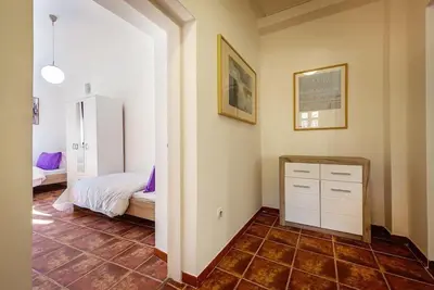 a bedroom with a bed and a tiled floor at Old Town Experience Apartment in Kotor