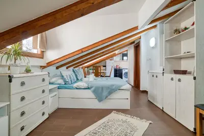 a bedroom with a bed and a large window at Lana & Ena Apartments in Kotor