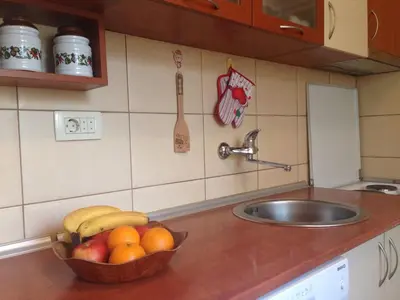a bowl of fruit on a kitchen counter with a sink at Apartment Adriatic - Budva in Budva