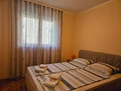 a bedroom with a bed with two towels on it at Apartment Adriatic - Budva in Budva