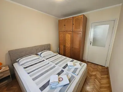 a bedroom with a bed with towels on it at Apartment Adriatic - Budva in Budva