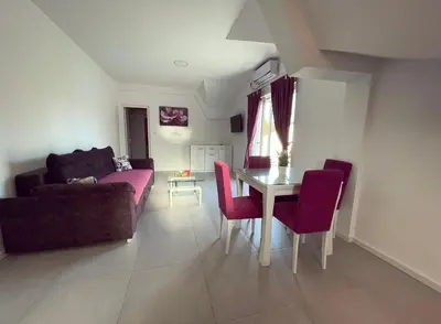 a living room with a couch and a table at Apartmani Agi in Budva
