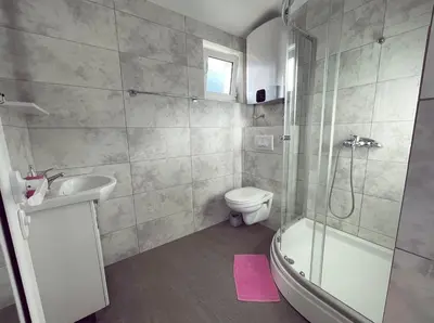 a bathroom with a toilet and a sink and a shower at Apartmani Agi in Budva