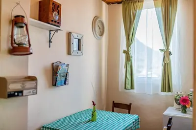 a room with a table with a vase on it at Guest House Luna in Virpazar