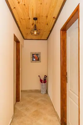 a hallway with a wooden ceiling at Guest House Luna in Virpazar