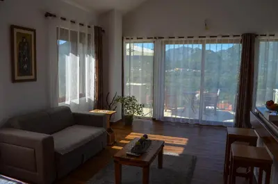 a living room with a couch and a table at Prevalis Nature Cottage in Virpazar