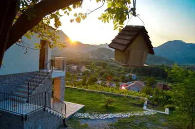 a building with stairs and a bird house at Prevalis Nature Cottage in Virpazar