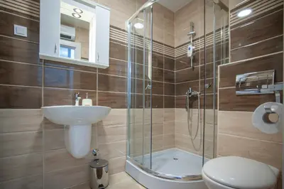 a bathroom with a toilet and a sink and a shower at Apartman 104 in Budva
