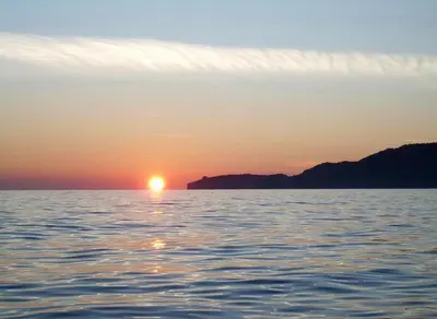 a sunset over a body of water at Apartments Ivanović in Budva