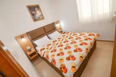 a bedroom with a bed with fruit on it at Apartments Ivanović in Budva