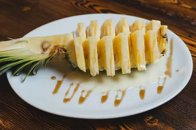 a white plate with a piece of food on it at Boscovich Boutique Hotel in Podgorica