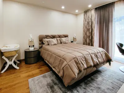 a bedroom with a large bed and a window at MAISON W in Kotor