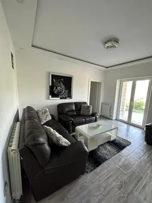 a living room with a leather couch and a coffee table at Vila Jovanka in Tivat
