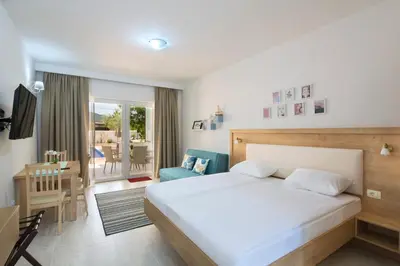 a bedroom with a bed and a living room at Luxurious Apartments Aria in Budva