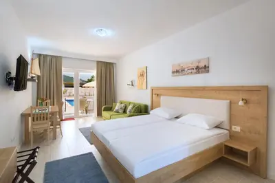 a bedroom with a bed and a living room at Luxurious Apartments Aria in Budva