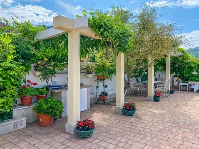 a cross on a brick patio with potted plants at Luxurious Apartments Aria in Budva