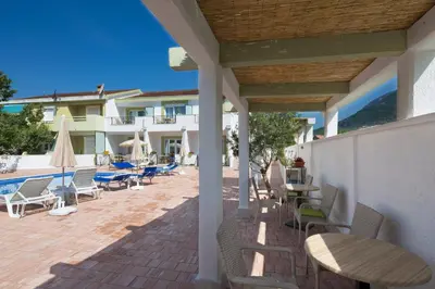 a patio with chairs and tables and a building at Luxurious Apartments Aria in Budva