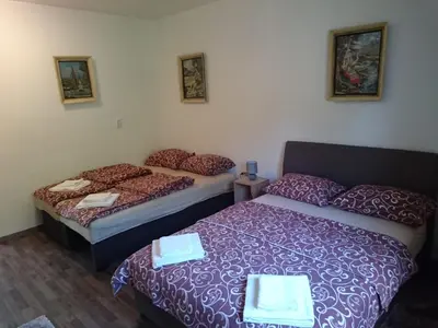 two beds sitting next to each other in a room at Studio and winery Kalimut in Virpazar