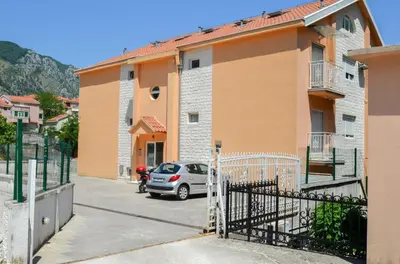 a car parked in a parking lot next to a building at Tea Lux Apartment in Kotor