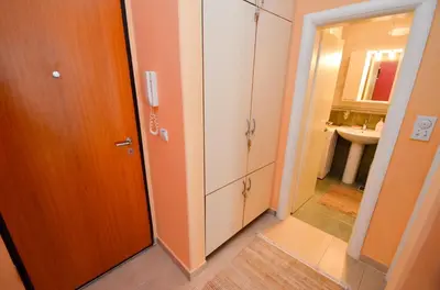 a bathroom with a toilet and a sink and a door at Tea Lux Apartment in Kotor
