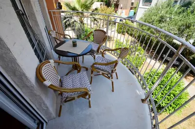 a balcony with a table and chairs on a balcony at Tea Lux Apartment in Kotor