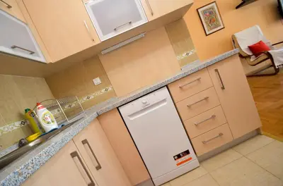 a kitchen with a dishwasher and a counter top at Tea Lux Apartment in Kotor