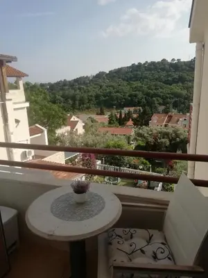 a table on a balcony with a view at Guest House Jedro in Petrovac na Moru
