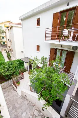 an external view of a building with a patio at Guest House Jedro in Petrovac na Moru