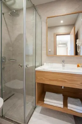 a bathroom with a shower and a sink at Hotel Vela in Budva