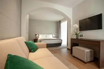a hotel room with a bed and a couch at Hotel Vela in Budva