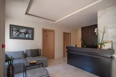 a living room with a couch and a fireplace at Hotel Vela in Budva