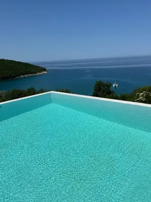 a swimming pool with a view of the water at Apartments Blue Heaven in Ulcinj