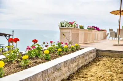 a retaining wall with flowers on a patio at Apartments Blue Heaven in Ulcinj