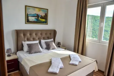 a bedroom with a bed with two pillows on it at Apartments Blue Heaven in Ulcinj