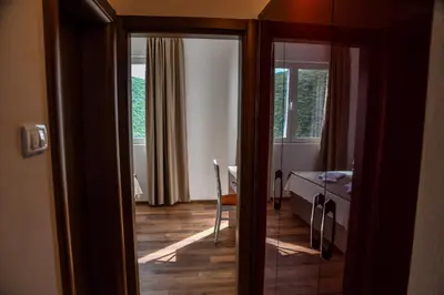 a room with a door open to a room with a table at Apartments Blue Heaven in Ulcinj